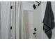 Bathroom with sleek shower, modern black hardware, and stylish shower curtain offers a spa-like experience at 589 Fox Creek Xing, Woodstock, GA 30188