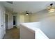 Hallway with carpet, ceiling fan, and doors leading to various rooms; stylish light fixture included at 589 Fox Creek Xing, Woodstock, GA 30188