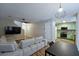 Open-concept living area featuring a comfortable sectional sofa and seamless flow to the kitchen at 589 Fox Creek Xing, Woodstock, GA 30188