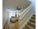 Living room with wood floors, ceiling fan and an area for dining offers style and comfortable living at 589 Fox Creek Xing, Woodstock, GA 30188