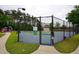 Community tennis court with fencing and signage, adjacent to playground at 589 Fox Creek Xing, Woodstock, GA 30188