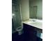 Bathroom featuring a vanity with dark wood cabinets, a shower with glass doors, and a toilet at 107 Highwood Ln, Atlanta, GA 30344