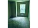 Bedroom with neutral walls, carpet flooring, and a single window at 107 Highwood Ln, Atlanta, GA 30344