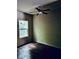 A basic bedroom with a ceiling fan, window and wood-look floors at 107 Highwood Ln, Atlanta, GA 30344