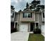 Charming townhome featuring a one-car garage, neutral siding, and a well-maintained front yard at 107 Highwood Ln, Atlanta, GA 30344