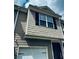 Close up of the exterior of a charming townhome featuring neutral siding and black shutters at 107 Highwood Ln, Atlanta, GA 30344