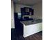 A minimalist kitchen featuring granite countertops, dark cabinets, a refrigerator and a stainless steel sink at 107 Highwood Ln, Atlanta, GA 30344