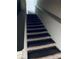 Carpeted stairs with white railing, leading upwards at 107 Highwood Ln, Atlanta, GA 30344
