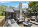 An inviting backyard deck with comfortable seating and a view of a peaceful, green yard at 2849 Beddington Way, Suwanee, GA 30024