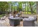 Inviting backyard deck with ample seating, grilling station, and mature trees offering shade and privacy at 2849 Beddington Way, Suwanee, GA 30024
