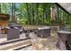 Spacious wooden deck with comfortable seating, a grilling area, and scenic views of the private backyard at 2849 Beddington Way, Suwanee, GA 30024