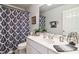 Well-lit bathroom featuring a single sink vanity, a large mirror, and a black and white patterned shower curtain at 2849 Beddington Way, Suwanee, GA 30024