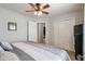 Bedroom with a ceiling fan, a comfortable bed, and closet space for ample storage; neutral paint throughout at 2849 Beddington Way, Suwanee, GA 30024