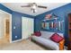 Bedroom featuring blue walls, closet space, and an adjacent bathroom for convenience and privacy at 2849 Beddington Way, Suwanee, GA 30024