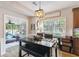 Bright breakfast nook featuring a black table and bench with backyard views, a great place for a gathering at 2849 Beddington Way, Suwanee, GA 30024