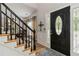 Elegant entryway with hardwood floors, staircase, and decorative front door at 2849 Beddington Way, Suwanee, GA 30024