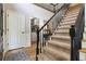 Welcoming entryway with wood floors, staircase, and closet at 2849 Beddington Way, Suwanee, GA 30024