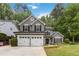 Charming two-story home featuring a two-car garage, manicured lawn and lush landscaping at 2849 Beddington Way, Suwanee, GA 30024