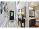 Bright and inviting foyer featuring a black front door, a console table, and a view of the upstairs at 2849 Beddington Way, Suwanee, GA 30024