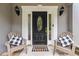Inviting front entryway featuring a black door, side windows, and comfortable seating at 2849 Beddington Way, Suwanee, GA 30024
