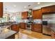 Kitchen with stainless steel appliances, granite countertops and hardwood floors near the nook at 2849 Beddington Way, Suwanee, GA 30024
