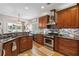 Kitchen view with granite counters and stainless appliances leading to nook, a chef's delight at 2849 Beddington Way, Suwanee, GA 30024