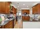 Kitchen with granite counters, stainless steel appliances and wood cabinets leading into dining room at 2849 Beddington Way, Suwanee, GA 30024