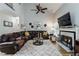 Inviting living room features a fireplace, ceiling fan, and comfortable leather seating at 2849 Beddington Way, Suwanee, GA 30024