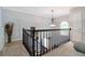 Open loft space with railing overlooking stairs and featuring plenty of natural light at 2849 Beddington Way, Suwanee, GA 30024