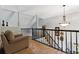 Open loft space with railing overlooking stairs and featuring plenty of natural light at 2849 Beddington Way, Suwanee, GA 30024