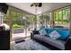 Relaxing sunroom featuring plenty of windows, modern furniture, and access to a backyard patio at 2849 Beddington Way, Suwanee, GA 30024