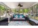 Relaxing sunroom featuring plenty of windows, modern furniture, and a ceiling fan at 2849 Beddington Way, Suwanee, GA 30024