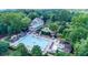 Aerial view of the community clubhouse with large pool, lounge areas and manicured landscaping at 3265 Bentwood Close, Cumming, GA 30041