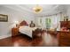 Spacious bedroom featuring a large window, hardwood floors, and elegant furnishings at 3265 Bentwood Close, Cumming, GA 30041