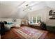 Bonus room featuring a vaulted ceiling, hardwood floors, and a casual seating area at 3265 Bentwood Close, Cumming, GA 30041