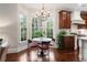 Sunlit breakfast nook featuring hardwood floors, and modern light fixture at 3265 Bentwood Close, Cumming, GA 30041
