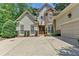 Charming two-story home featuring stone accents, a double door entryway, and an attached two-car garage at 3265 Bentwood Close, Cumming, GA 30041