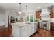 Bright kitchen features a central island, stainless steel appliances, and views into the living room at 3265 Bentwood Close, Cumming, GA 30041