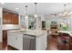 Open kitchen featuring an island and stainless appliances seamlessly flows into the adjacent living area at 3265 Bentwood Close, Cumming, GA 30041