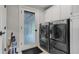 Practical laundry room with modern washer and dryer, plus storage cabinets for organization at 3265 Bentwood Close, Cumming, GA 30041