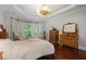 Spacious bedroom with hardwood floors, sitting area, and natural light at 3265 Bentwood Close, Cumming, GA 30041