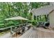 Inviting outdoor deck with a pergola, patio furniture, and views of the wooded surroundings at 3265 Bentwood Close, Cumming, GA 30041