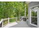 Covered outdoor deck with gray railings, serene wooded views, and a tranquil retreat at 3851 Glenhurst Se Dr, Smyrna, GA 30080