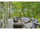 A cozy outdoor living space featuring a gray sofa, two chairs, and a fire pit perfect for relaxing outdoors at 3851 Glenhurst Se Dr, Smyrna, GA 30080
