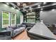 An elegant basement bar with rich green wall, modern lighting, and a seating area for a relaxing space at 3851 Glenhurst Se Dr, Smyrna, GA 30080