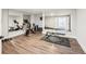 Bright basement gym featuring a mirrored wall, exercise equipment, and durable flooring for an ideal workout space at 3851 Glenhurst Se Dr, Smyrna, GA 30080