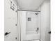 Modern bathroom with herringbone tile shower and black fixtures at 3851 Glenhurst Se Dr, Smyrna, GA 30080