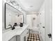 Elegant bathroom with double vanity, quartz countertop, modern fixtures, tiled shower, and patterned rug at 3851 Glenhurst Se Dr, Smyrna, GA 30080