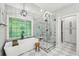 Stunning bathroom with a soaking tub, walk-in shower, and elegant light fixture at 3851 Glenhurst Se Dr, Smyrna, GA 30080