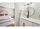 Bathroom with white vanity, black fixtures, decorative mirror, and a view to the bedroom at 3851 Glenhurst Se Dr, Smyrna, GA 30080
